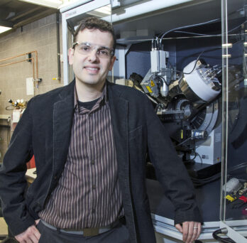 Prof. Cabana stands by an X-ray diffractometer, an instrument that characterized energy storage materials.
                  