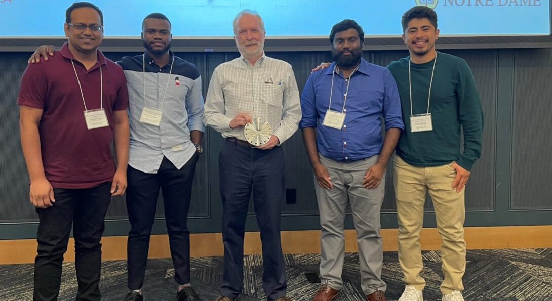 Mike Trenary stands next to his group members after being awarded the 2022 Outstanding Researcher Award.